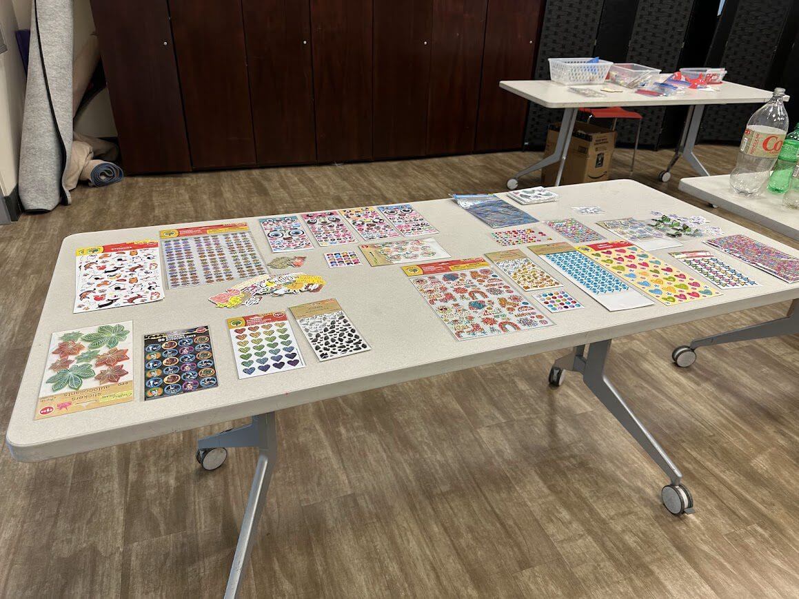 Table covered with colorful sticker sheets